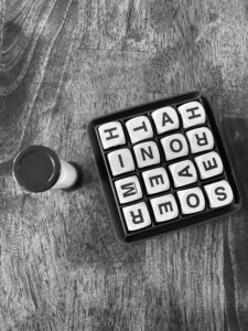 A black-and-white photo of a Boggle board and timer